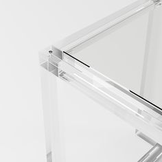 a clear glass table with metal legs on white background, showing the top section and bottom portion