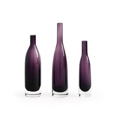 three purple vases sitting next to each other