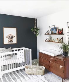 a baby's room with a crib, dresser and pictures on the wall