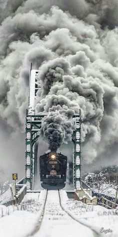 the train is coming down the tracks in the snow