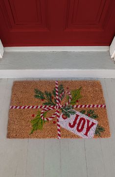 a christmas door mat with the word joy on it