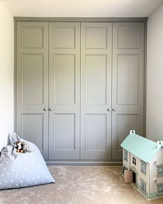 there is a dog bed in the corner of this room with built - in closets