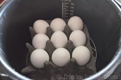 a bucket filled with eggs sitting on top of a table