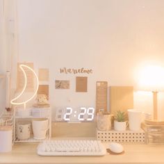 a desk with a keyboard, mouse and clock on it