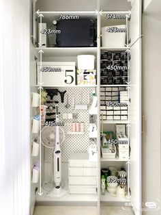 the closet is full of items and labeled with measurements for each item, including an ironing board