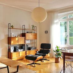 a living room filled with furniture and a large window