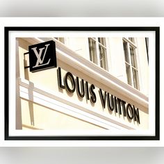 a louis vuitton store sign on the side of a building in paris, france