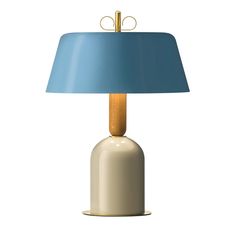 a white table lamp with a blue shade on the base and a wooden stick sticking out of it