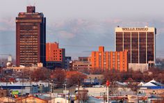 a city with tall buildings and mountains in the background