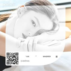 a woman laying on top of a bed next to a window with qr code