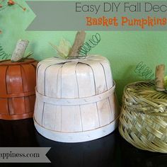 three decorative pumpkins sitting on top of a table