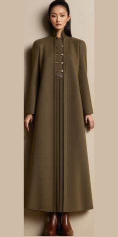 Elevate your fall wardrobe with this stunning olive green, military-inspired long coat. The structured silhouette, high collar, and button detailing exude timeless sophistication, perfect for a chic, minimalist look. Pair it with ankle boots for a polished, modern style. Ideal for cold weather and versatile enough for both formal and casual settings.  #FallFashion #MilitaryCoat #LongCoat #OliveGreen #MinimalistStyle #ElegantOuterwear #ChicFashion #TimelessStyle #AutumnOutfit #CoatForWinter Chanel 2024, Winter Coat Dress, Abaya Design, Military Coat, Muslim Fashion Dress, Muslim Fashion Outfits, Fashion Hacks Clothes