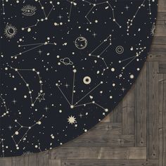 an area rug with various stars and planets on it, along with wood flooring