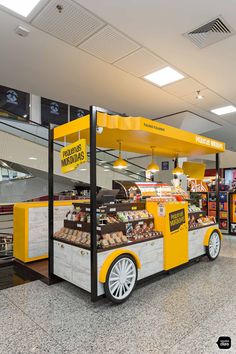 an orange and white food cart sitting inside of a building