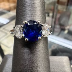 a blue ring with three diamonds on it