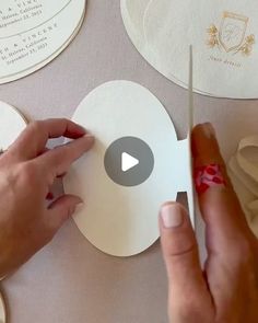 someone is cutting out some paper circles with a pair of scissors on top of it