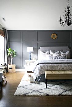 a bedroom with gray walls and white bedding