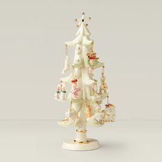 a white christmas tree with ornaments hanging from it