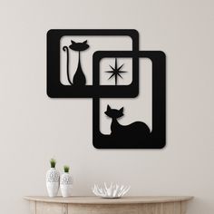 a wall mounted clock with two cats on it