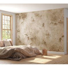 a bed sitting in a bedroom under a window next to a wall with birds on it