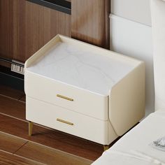 a bed with a white blanket and two drawers