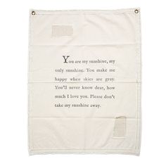 a white towel with an embroidered poem on it