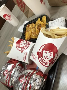 fries, onion rings and chicken wings are on a tray at a fast food restaurant