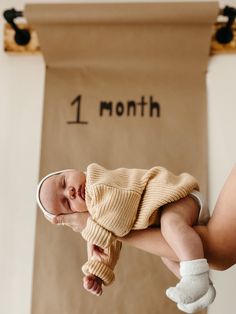 a baby is laying on its back in the air