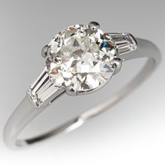 an old mine cut diamond ring with baguettes on the side and tapered shoulders