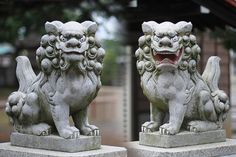 two stone lions sitting next to each other