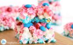 there are many candy treats stacked on top of each other with blue and pink candies