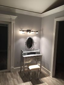 an empty room with a vanity and mirror