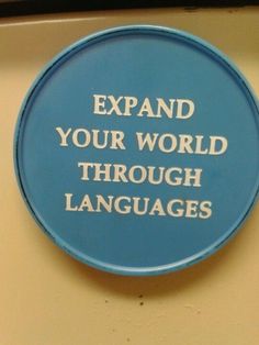 a blue sign that says expand your world through languages