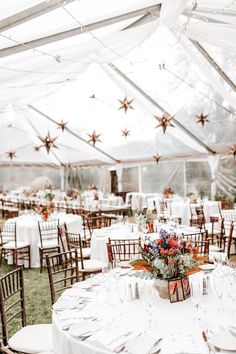 an outdoor tent with tables and chairs set up