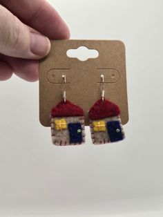 a pair of earrings that have been made to look like houses