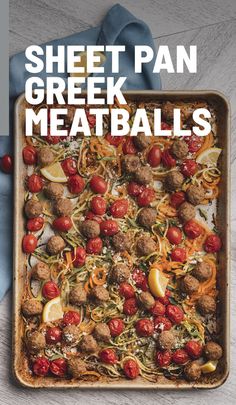 a sheet pan filled with meatballs and pasta on top of a table next to a fork