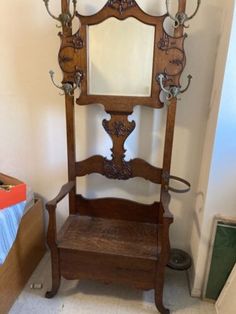 an old wooden chair with a mirror on it's back and shelf below the mirror