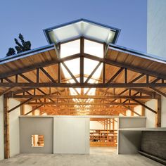 the inside of a building that is being built with wood and glass on it's roof