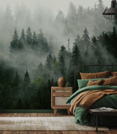 a bed room with a neatly made bed next to a forest wall mural