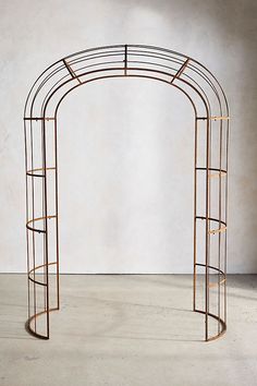 an iron arch with shelves on the side