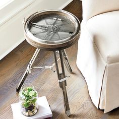 a table with a compass on it next to a couch