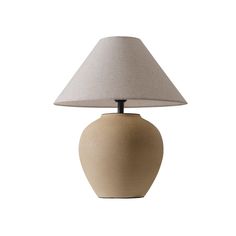 a table lamp with a white shade on it's base and a light bulb in the shape of a vase