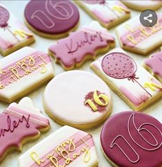 decorated cookies with pink and white frosting on a table