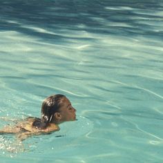 a person swimming in the water with a frisbee