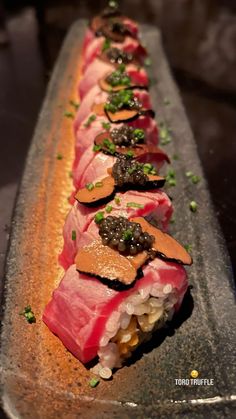 a long rectangular platter with sushi on it