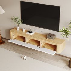 a flat screen tv mounted to the side of a wooden entertainment center in a living room