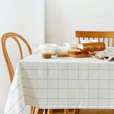 the table is set with bread and coffee