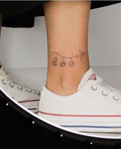 a woman's foot with an airplane tattoo on her left ankle and the word love written in small letters