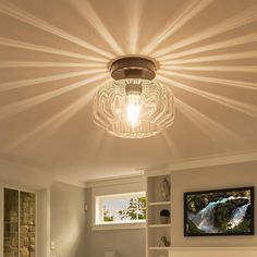 a bedroom with a bed, book shelf and ceiling light