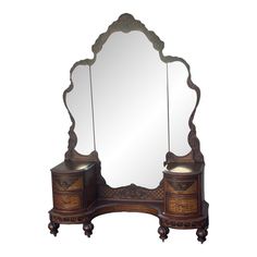 an ornate wooden vanity with mirror and drawers